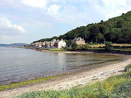 Kilchattan Bay on the Isle of Bute, with rust-coloured sand, rock pools and a calm south-east coast view