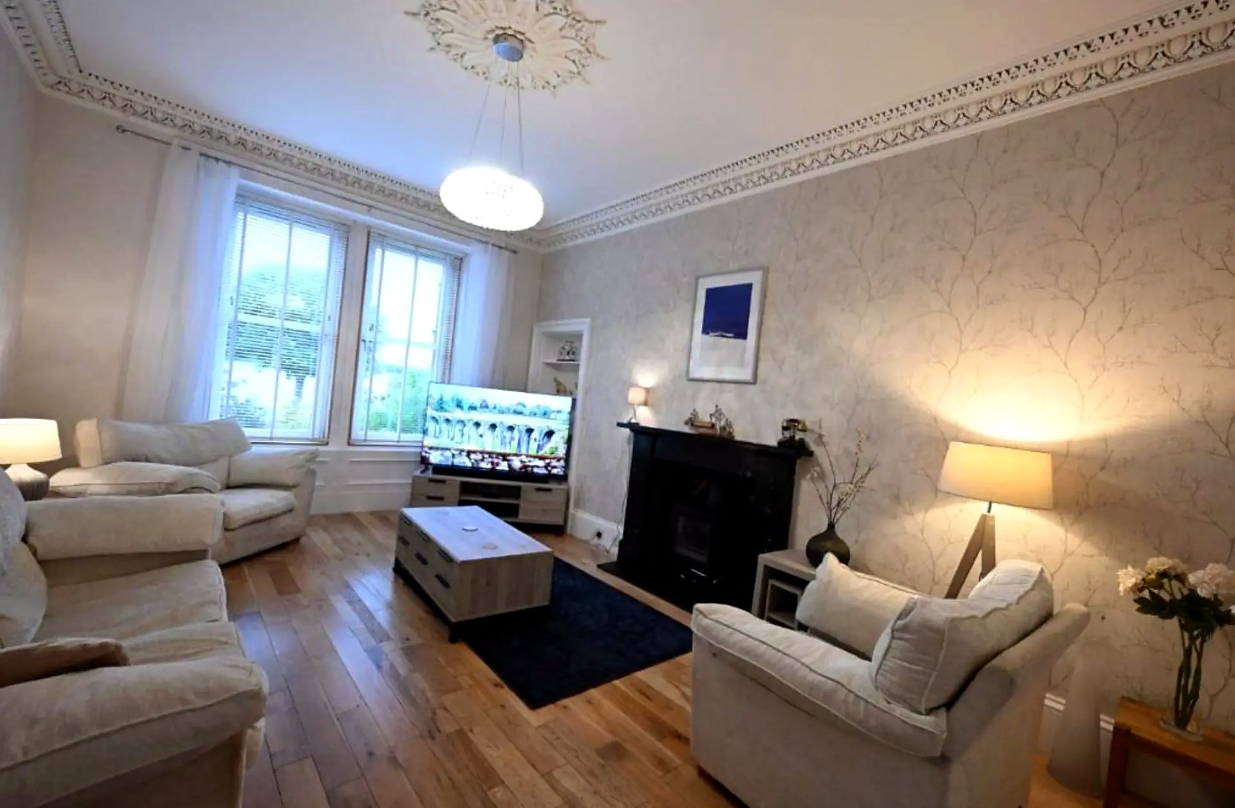 Second sitting room at Harbour View with a black cast-iron fireplace and ornate ceiling cornice
