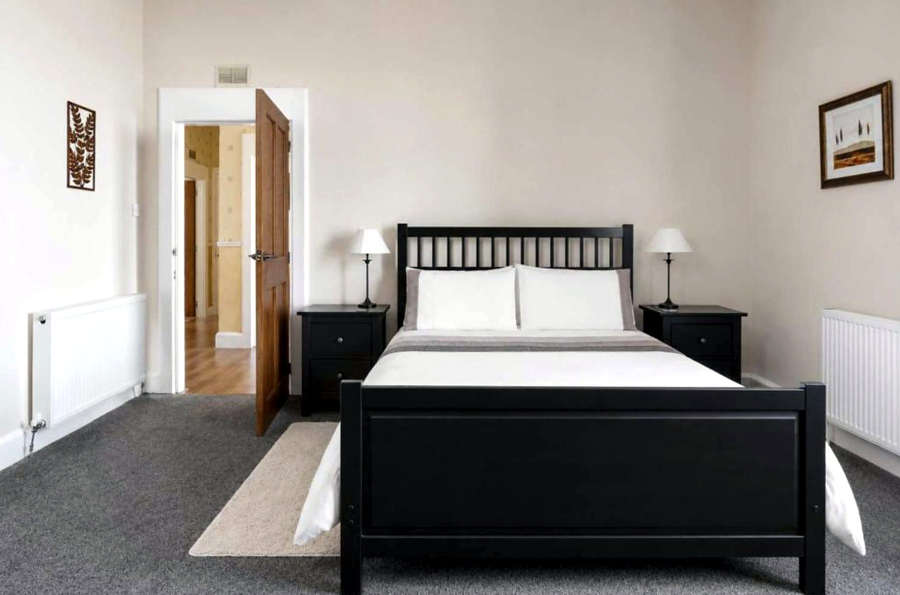 Double bedroom at Ardyne House with grey carpet and matching bedside tables