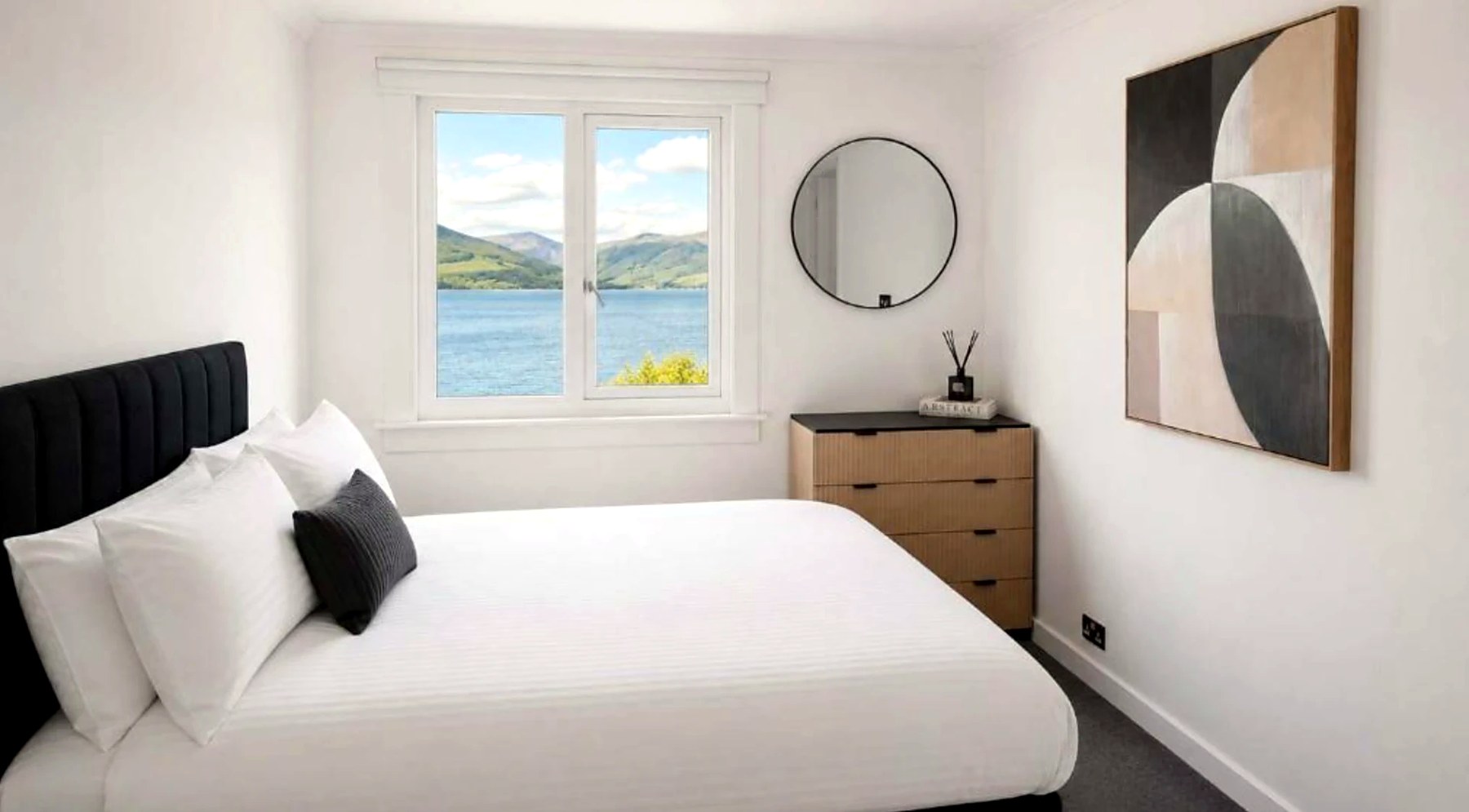 Double bedroom at Bayview at the Port with a window over the water to the hills