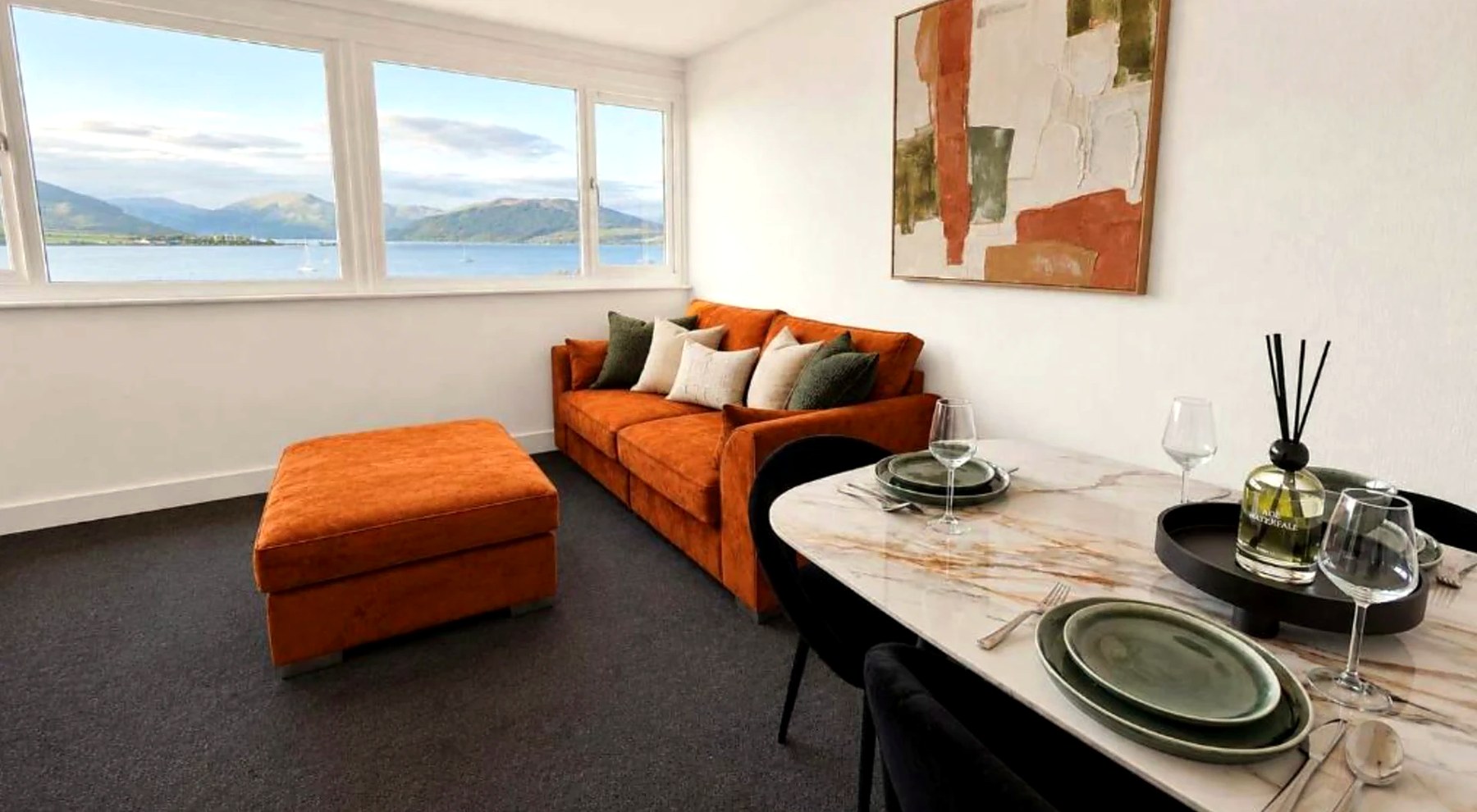 Open-plan living and dining space at Bayview at the Port looking out over the water