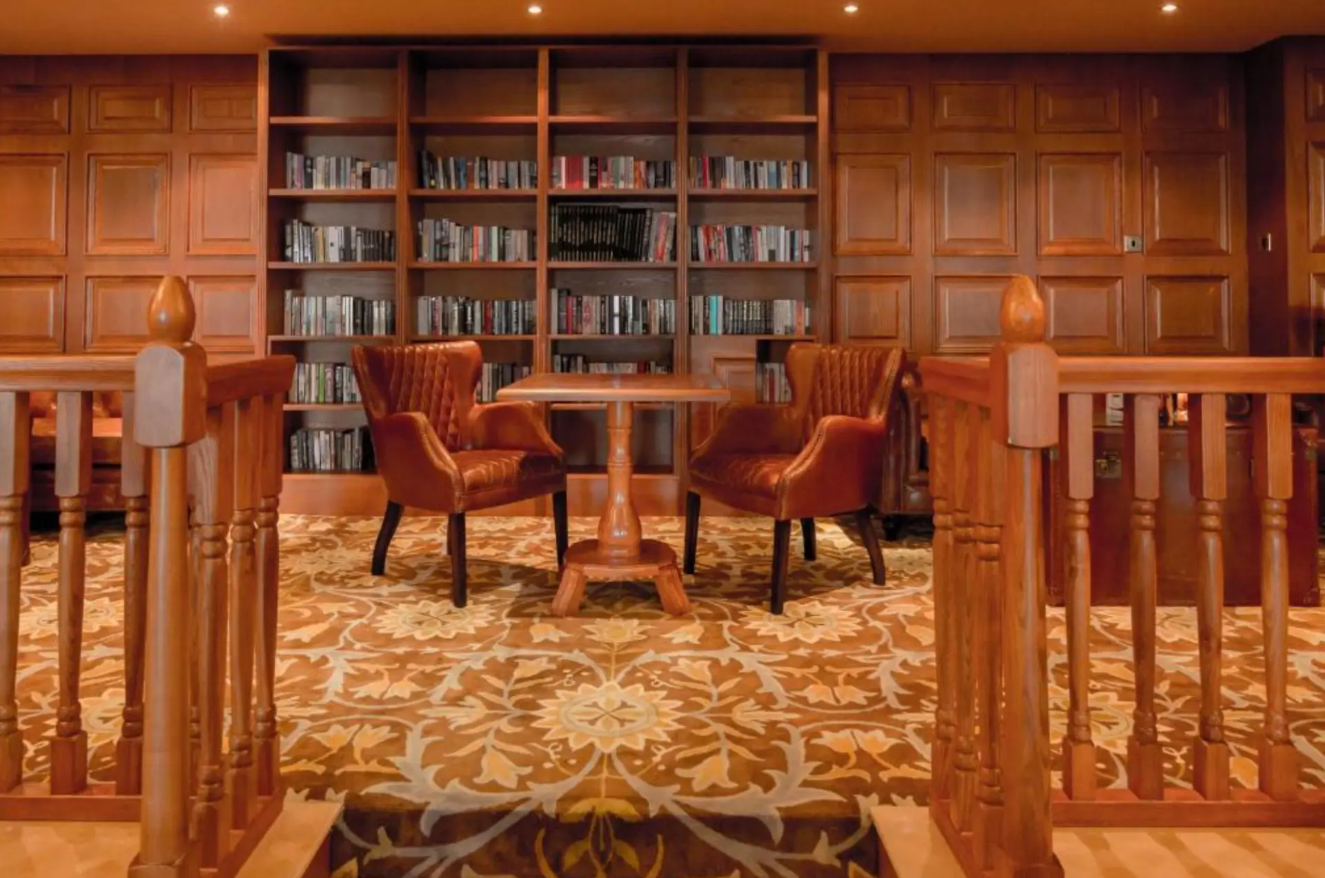 The library lounge at The Glenburn Hotel with armchairs and bookshelves