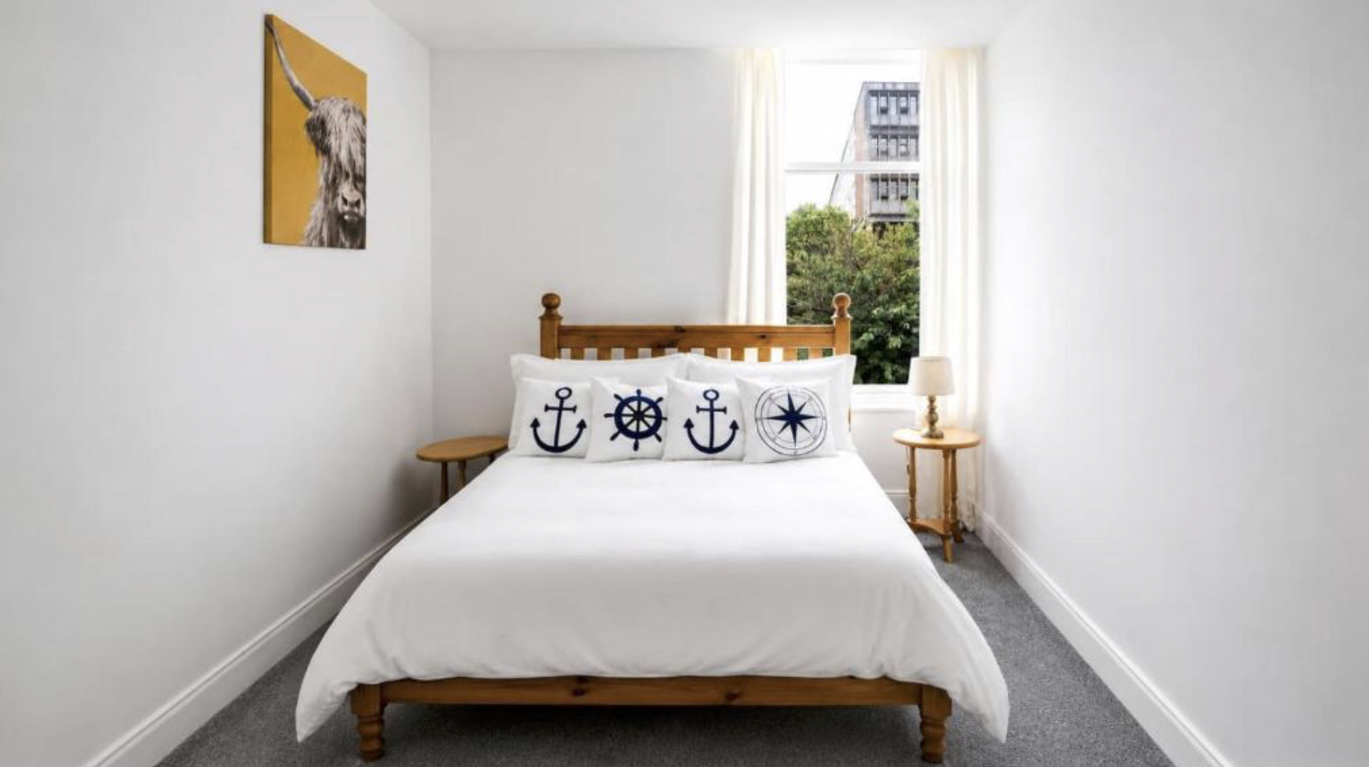 The double bedroom at The Hidden Asset with white linen and a pine bed frame