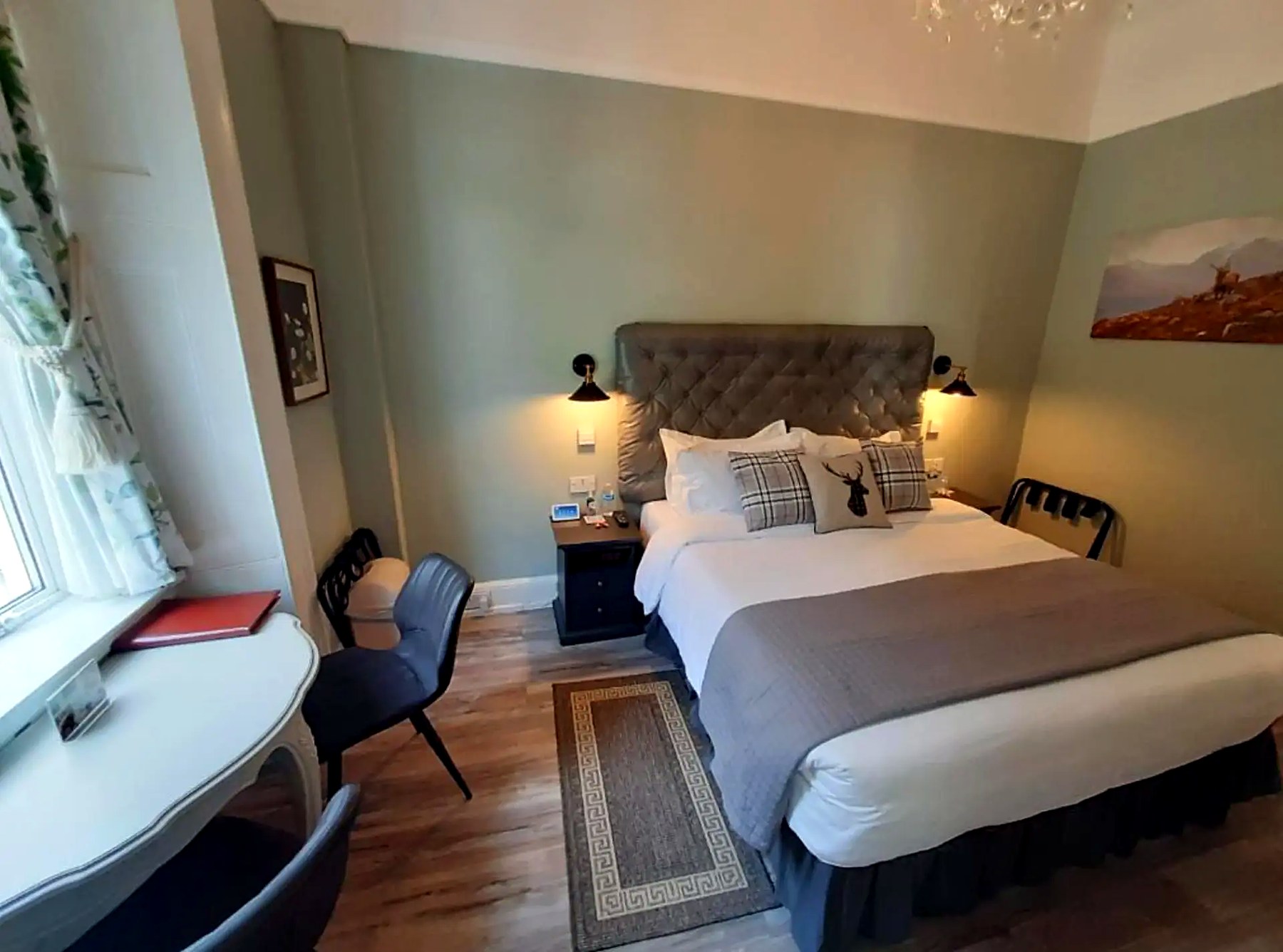 Bedroom at Highlander House with a dressing table, chairs and stag-print cushions