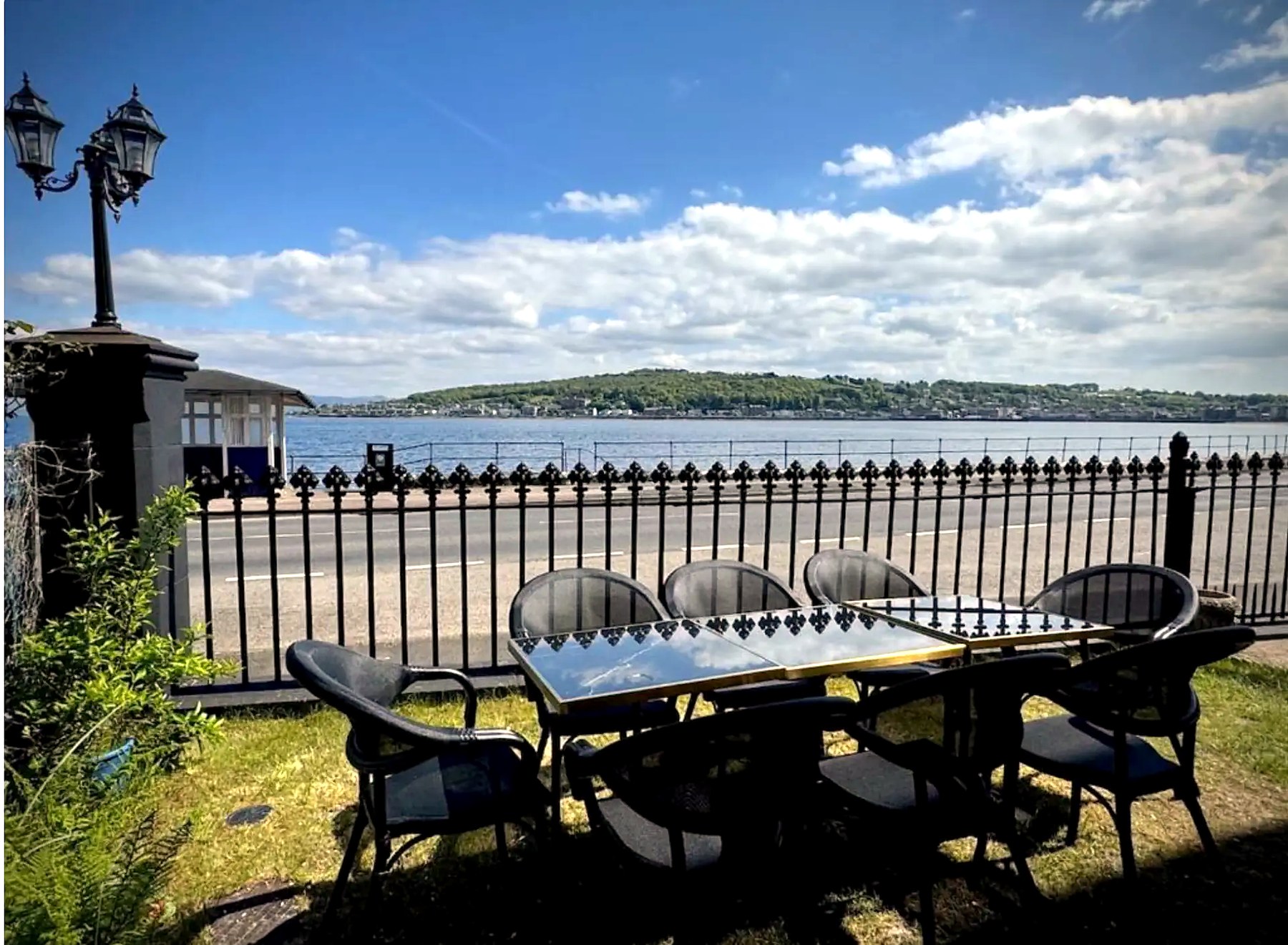 Outdoor table and chairs looking across the water from The Old Church