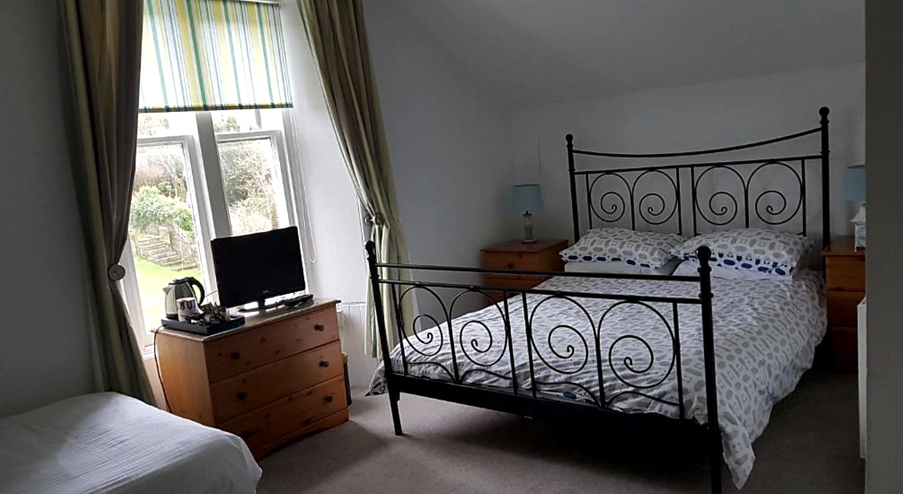 Family room at St Ebba's with a double bed, single bed and garden-facing window