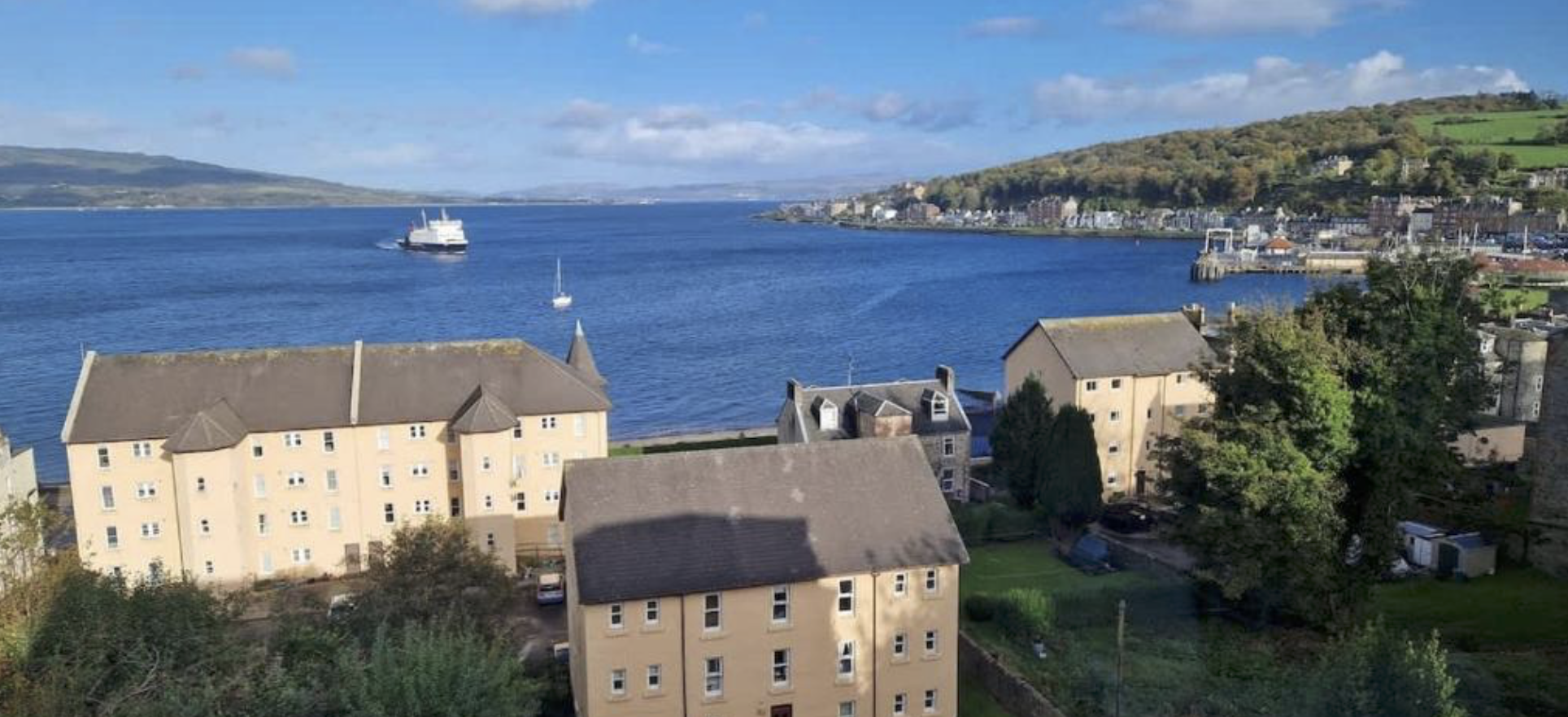 The view from The Hidden Asset over Rothesay Bay with the CalMac ferry crossing