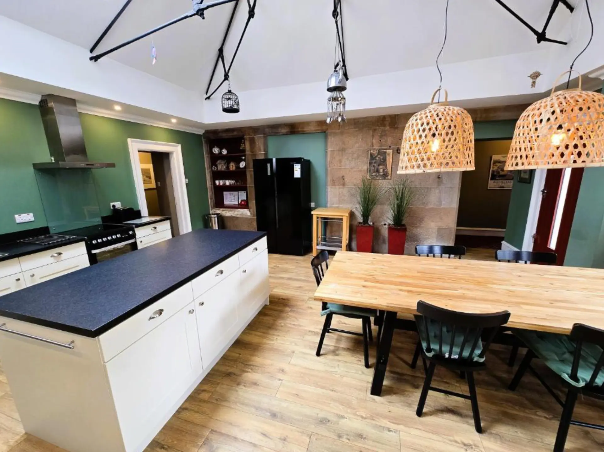 The kitchen island, range cooker and dining table at Balmory Stables, Isle of Bute