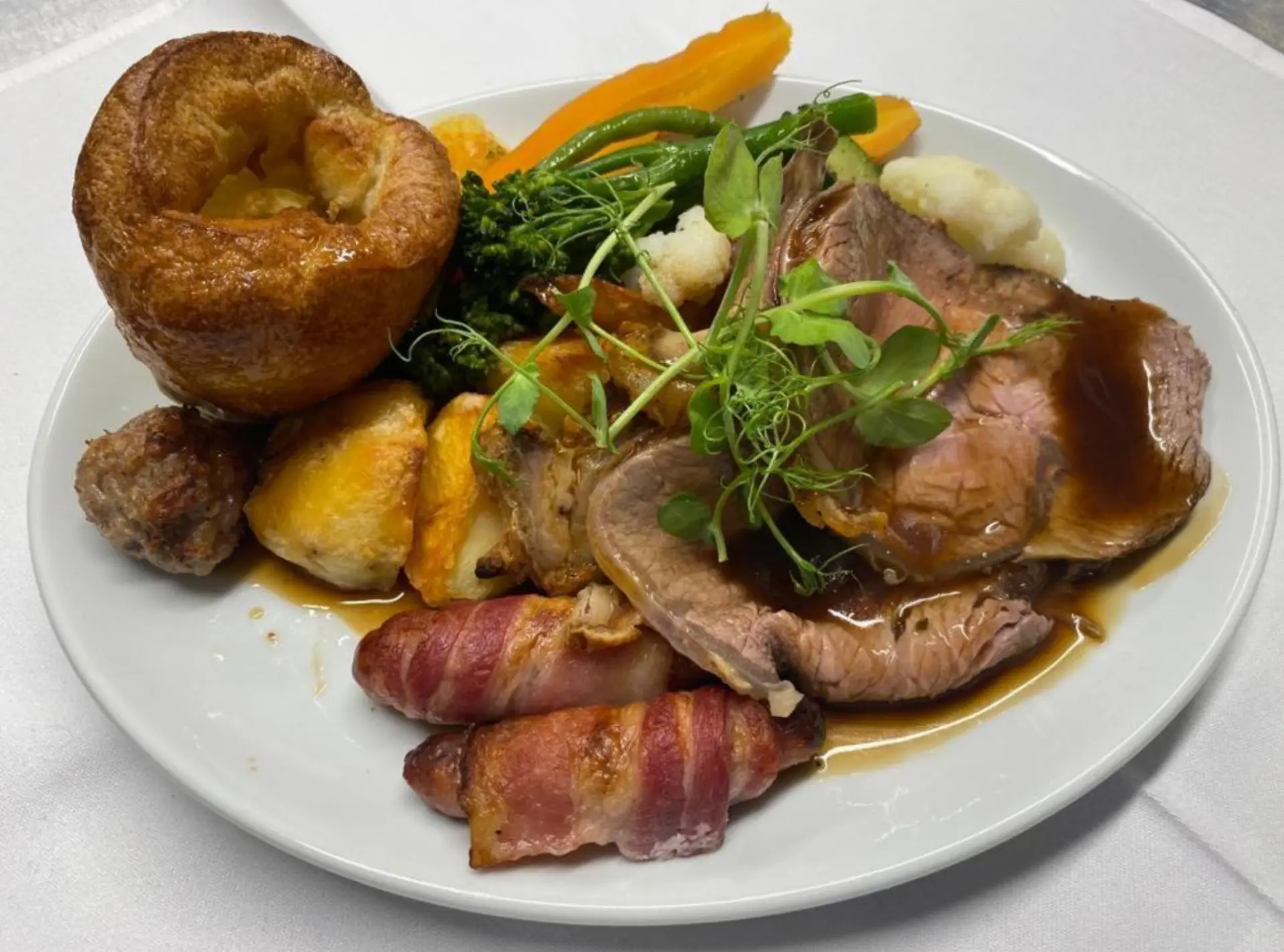 A Sunday roast at the Kingarth Hotel: sliced beef, Yorkshire pudding, roast potatoes and pigs in blankets