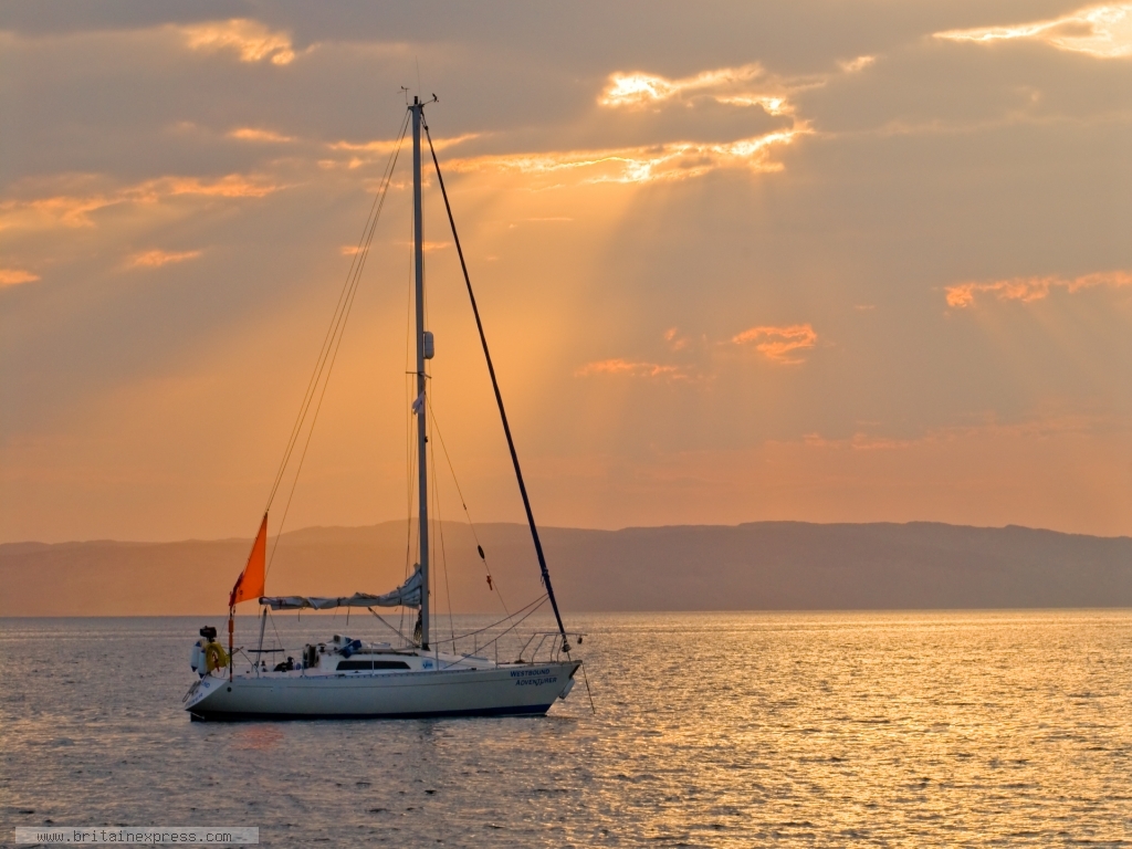 Yacht at anchor off Bute at sunset on the Firth of Clyde