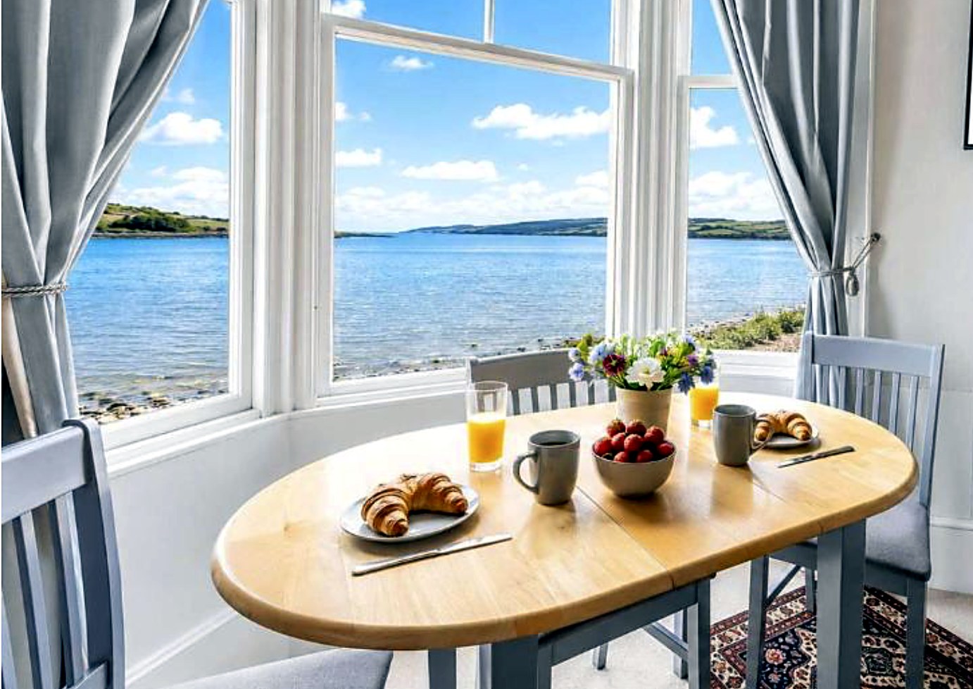 Dining table with a sea view at Govandale Seaviews, Isle of Bute