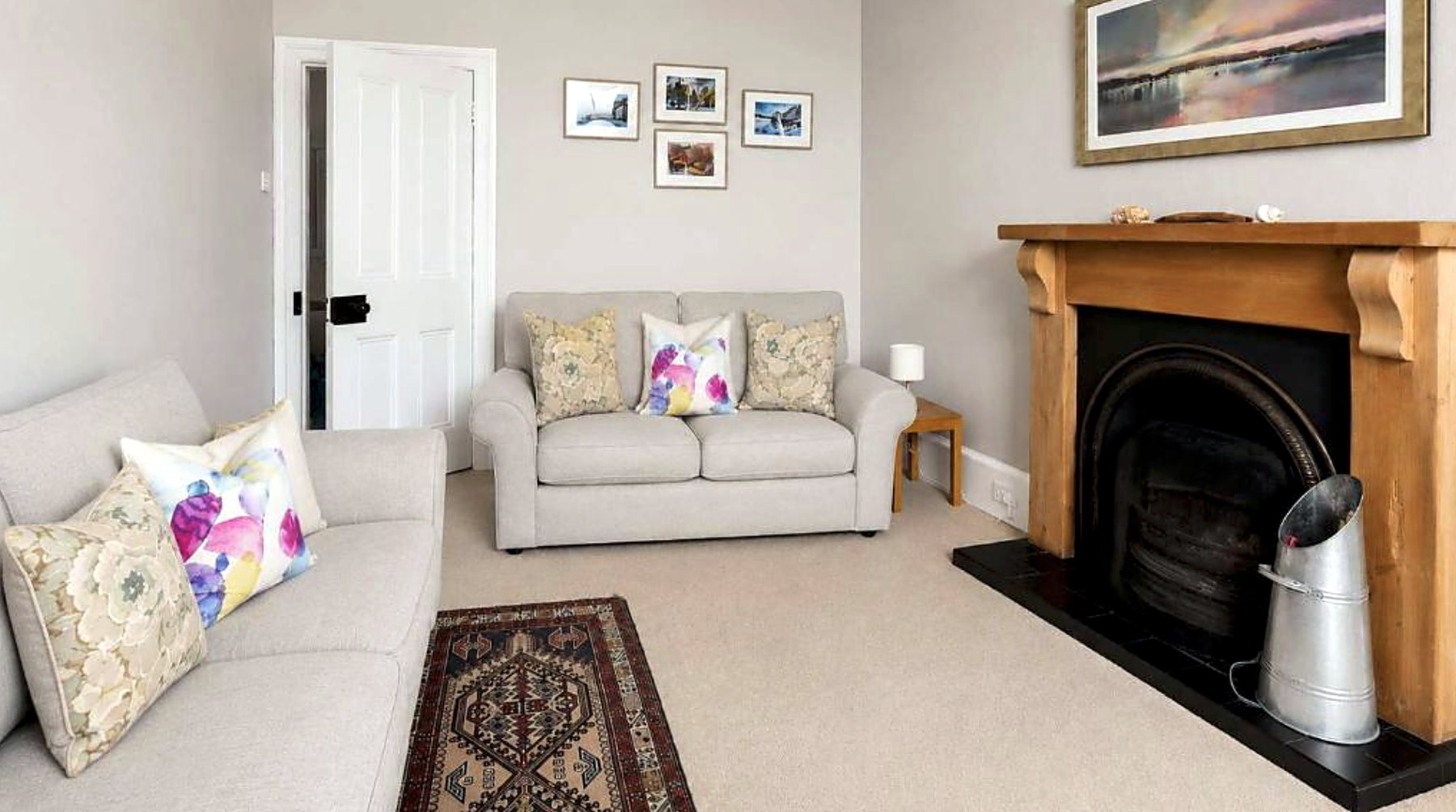 Sitting room at Govandale Seaviews with two sofas and an open fireplace