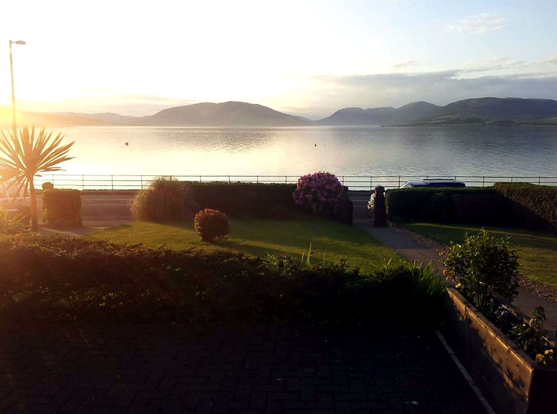 Sunrise over Rothesay Bay and the Argyll hills, seen from St Ebba's front garden