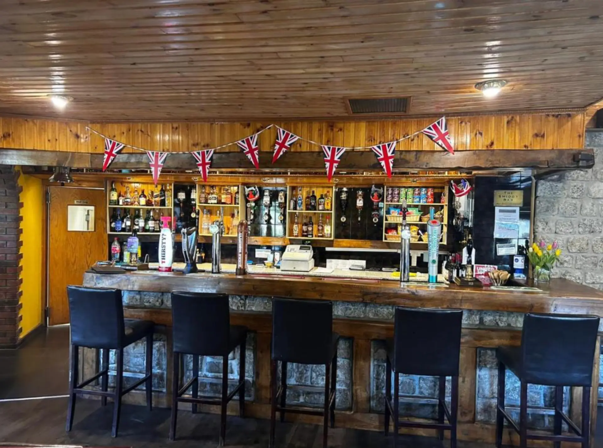 The timber and stone counter of the Smiddy Bar at the Kingarth Hotel