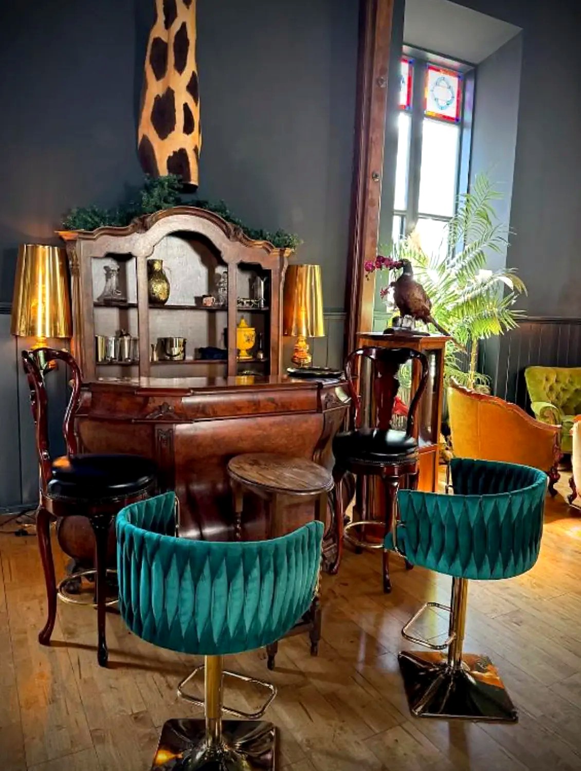 Antique bar with velvet stools in the hall at The Old Church