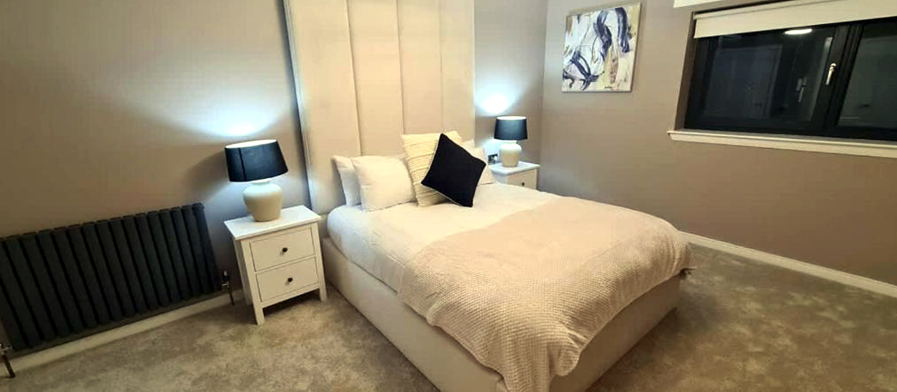 Double bedroom with upholstered bed at The Old Courthouse in Rothesay