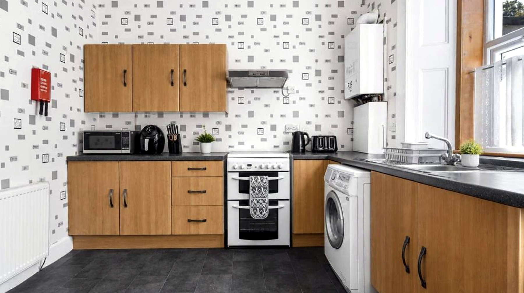 Guest kitchen at Ardyne House with oven, microwave, kettle and washing machine