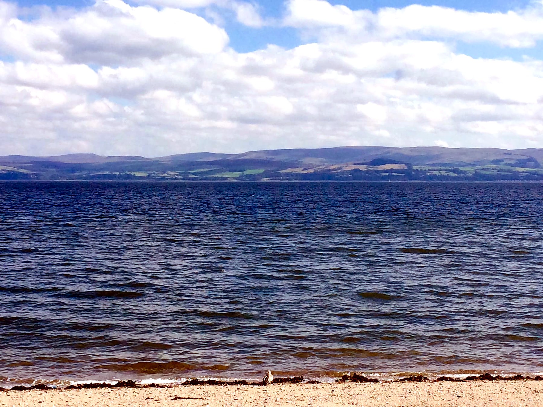 Blue water and the Ayrshire hills seen from the shore at Kerrycroy, Isle of Bute