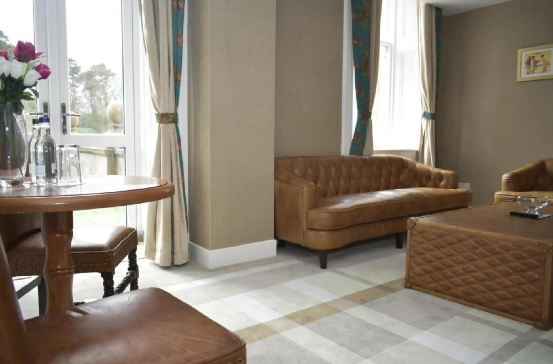 Sitting area of a suite at The Glenburn Hotel with sofa and armchairs