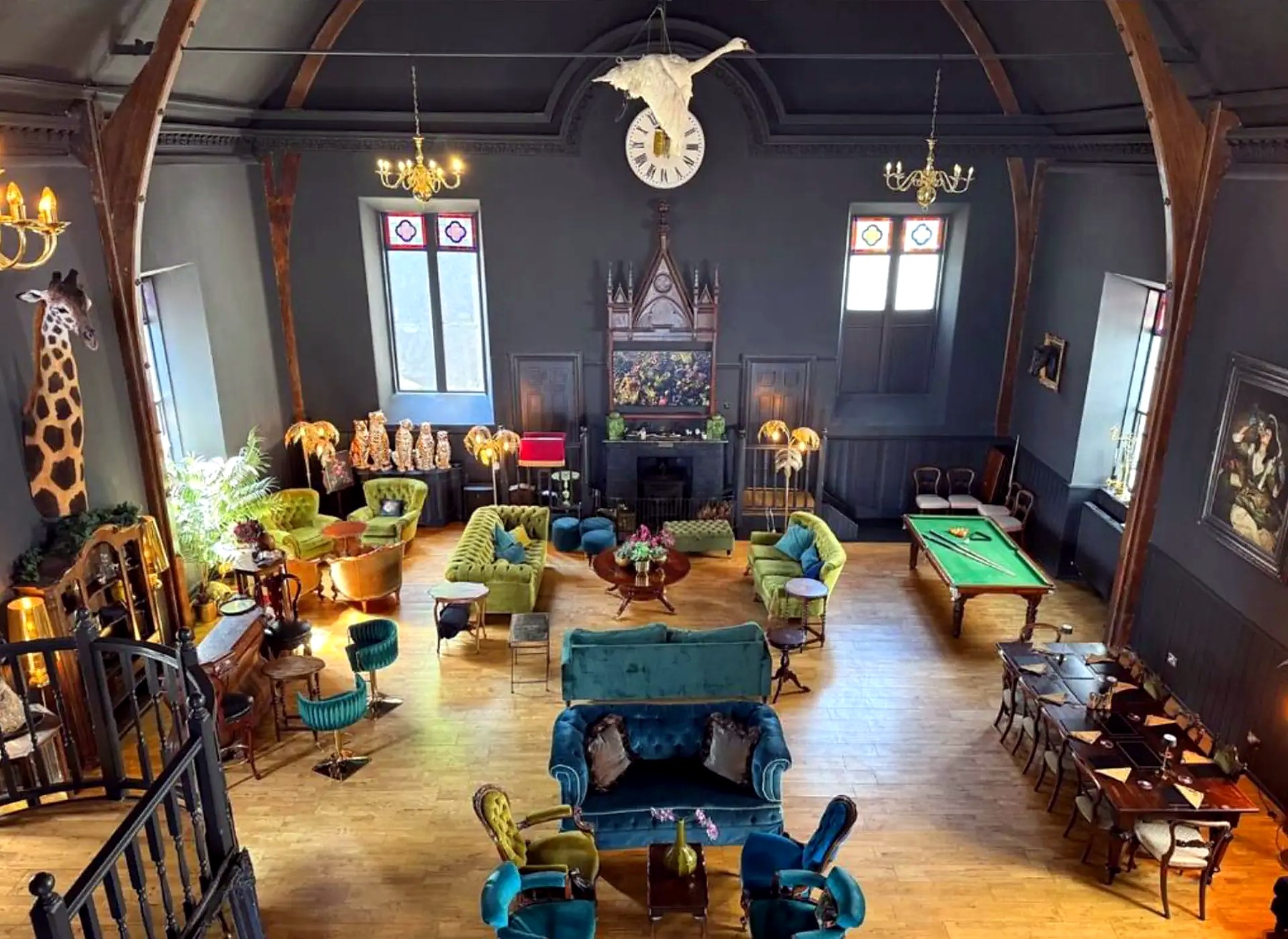 View from the mezzanine over the great hall at The Old Church, with pool table and velvet sofas