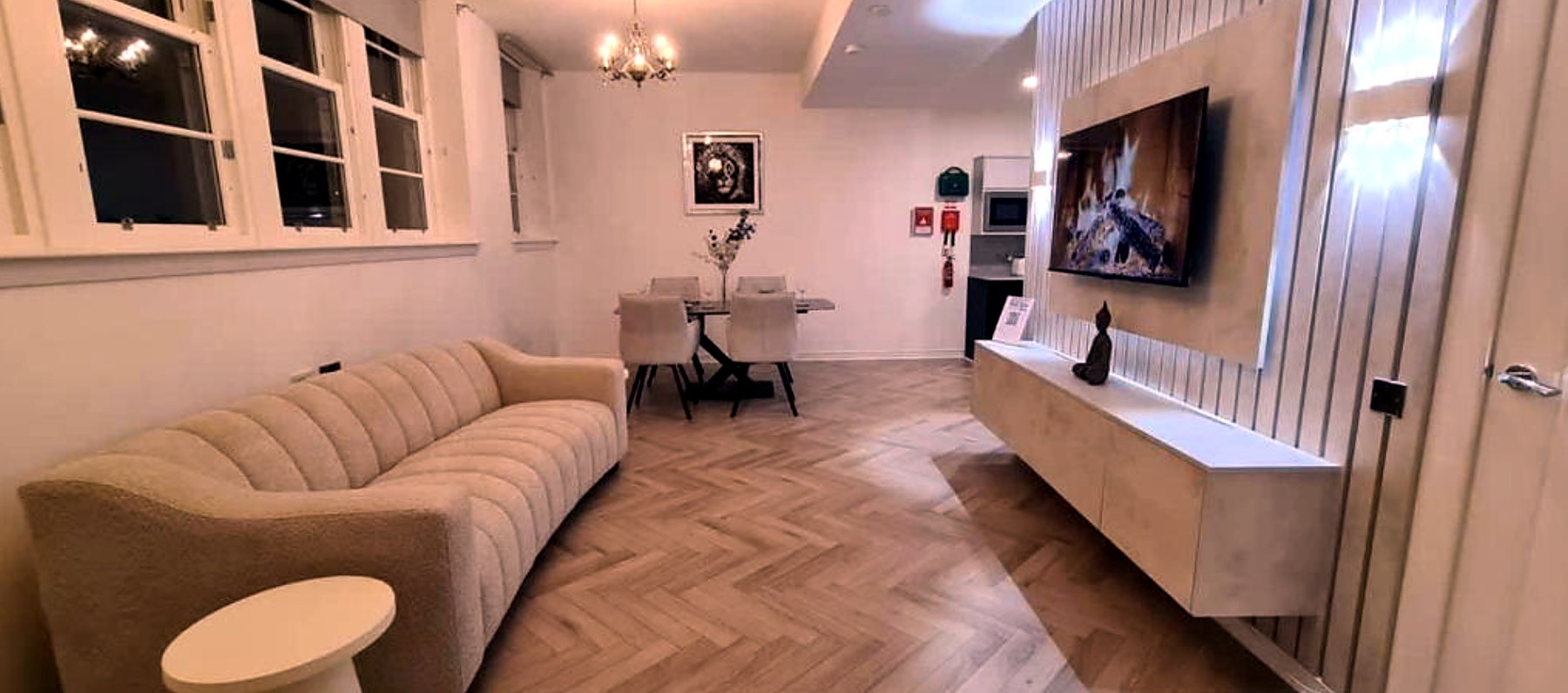 Spacious living room with curved sofa and dining area at The Old Courthouse
